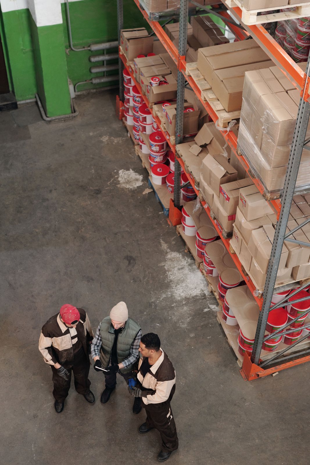 Warehouse workers coordinating inventory